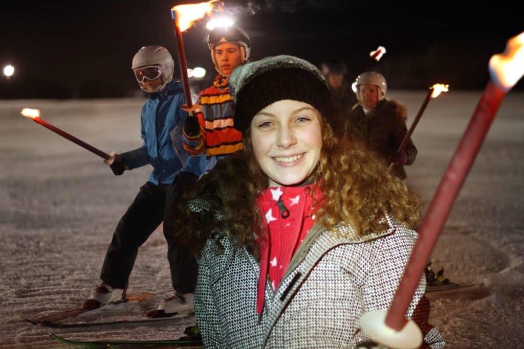 A group of friends skiing, which one of the best things to do in Red River, NM.
